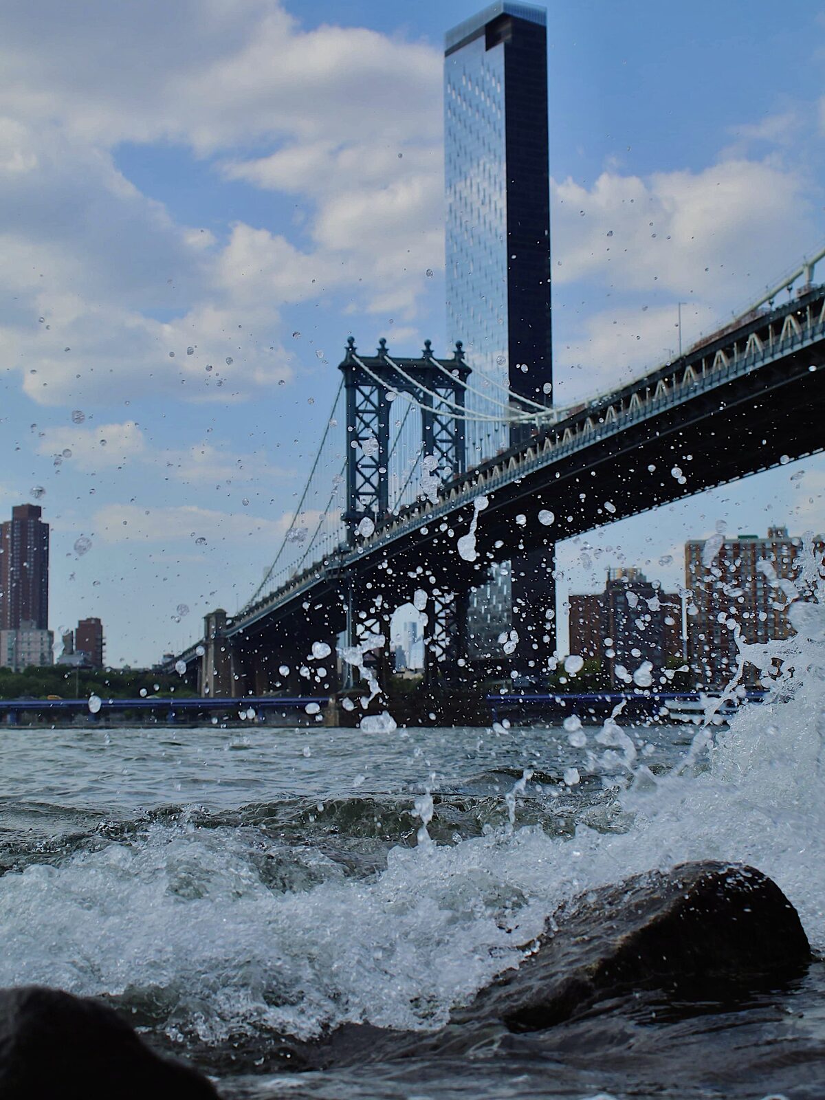Water splashing in front of the Manhattan Bridge, New York City